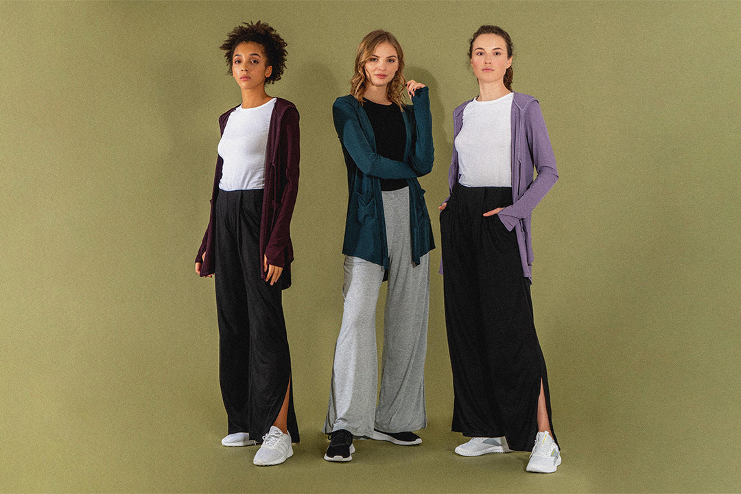 Three females posing in their Move It Cardigans and Swift Wide-Leg Sweatpants, two modest activewear products from Veil Garments