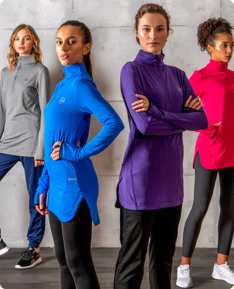 Four females wearing Veil Garments modest activewear products, consisting of the Spark Half-Zip and Glider Drawstring Jogger.