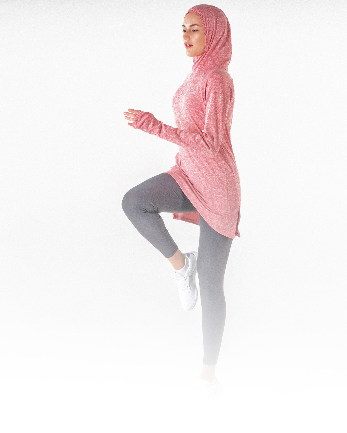 A female working out in the heathered red Halo Running Hoodie, a modest sportswear sweatshirt from Veil Garments.