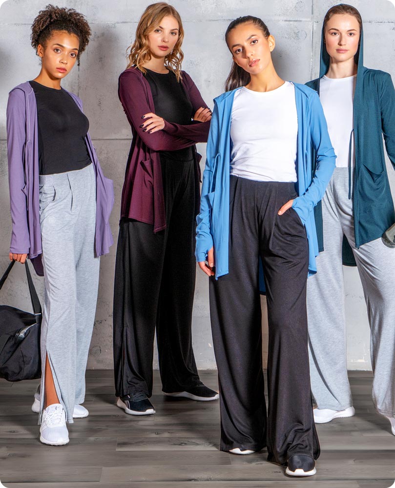 Four females wearing Veil Garments' modest sportswear, consisting of the Move It Cardigan and Swift Wide-Leg Sweatpant.