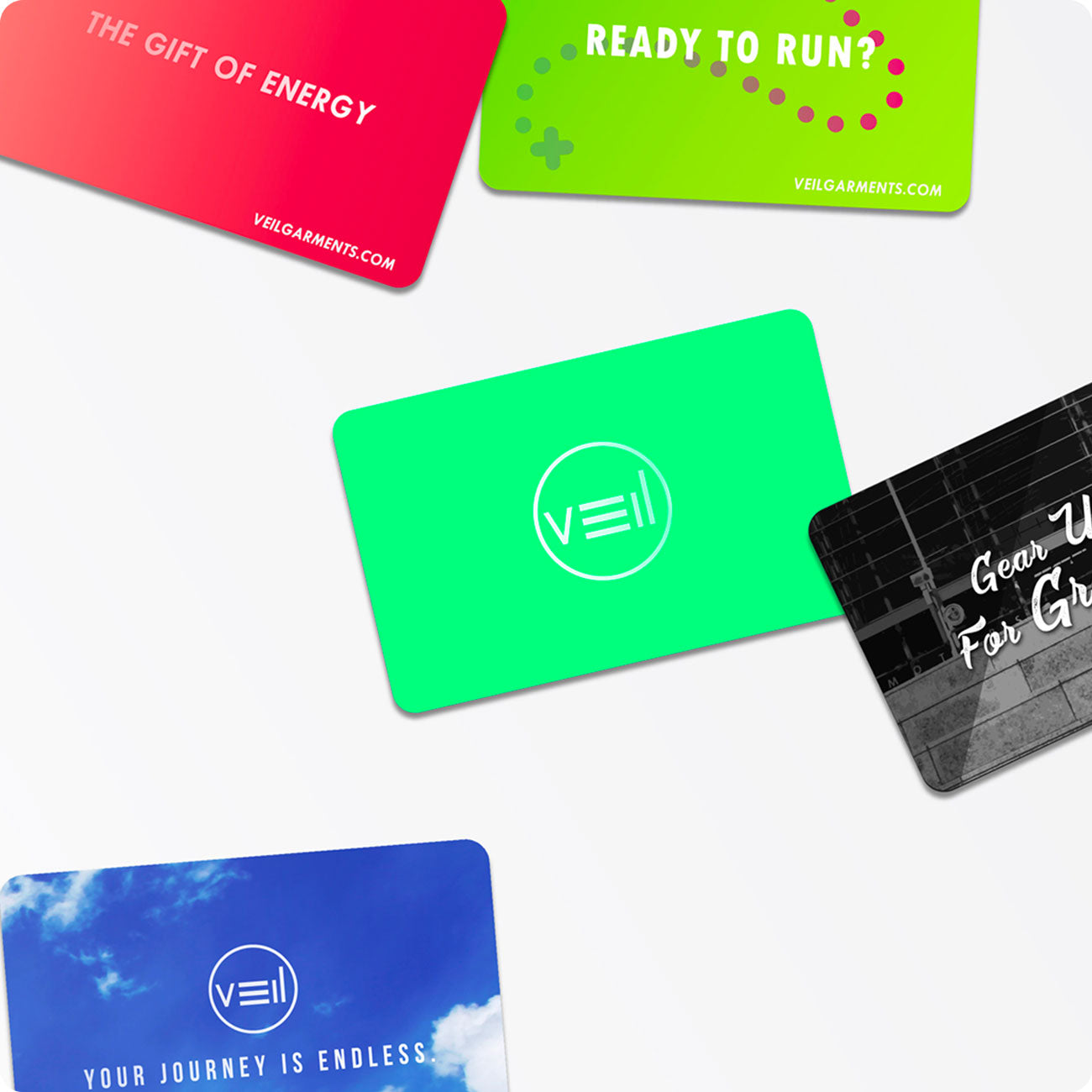 A variety of Veil Garments gift cards scattered across a white background.