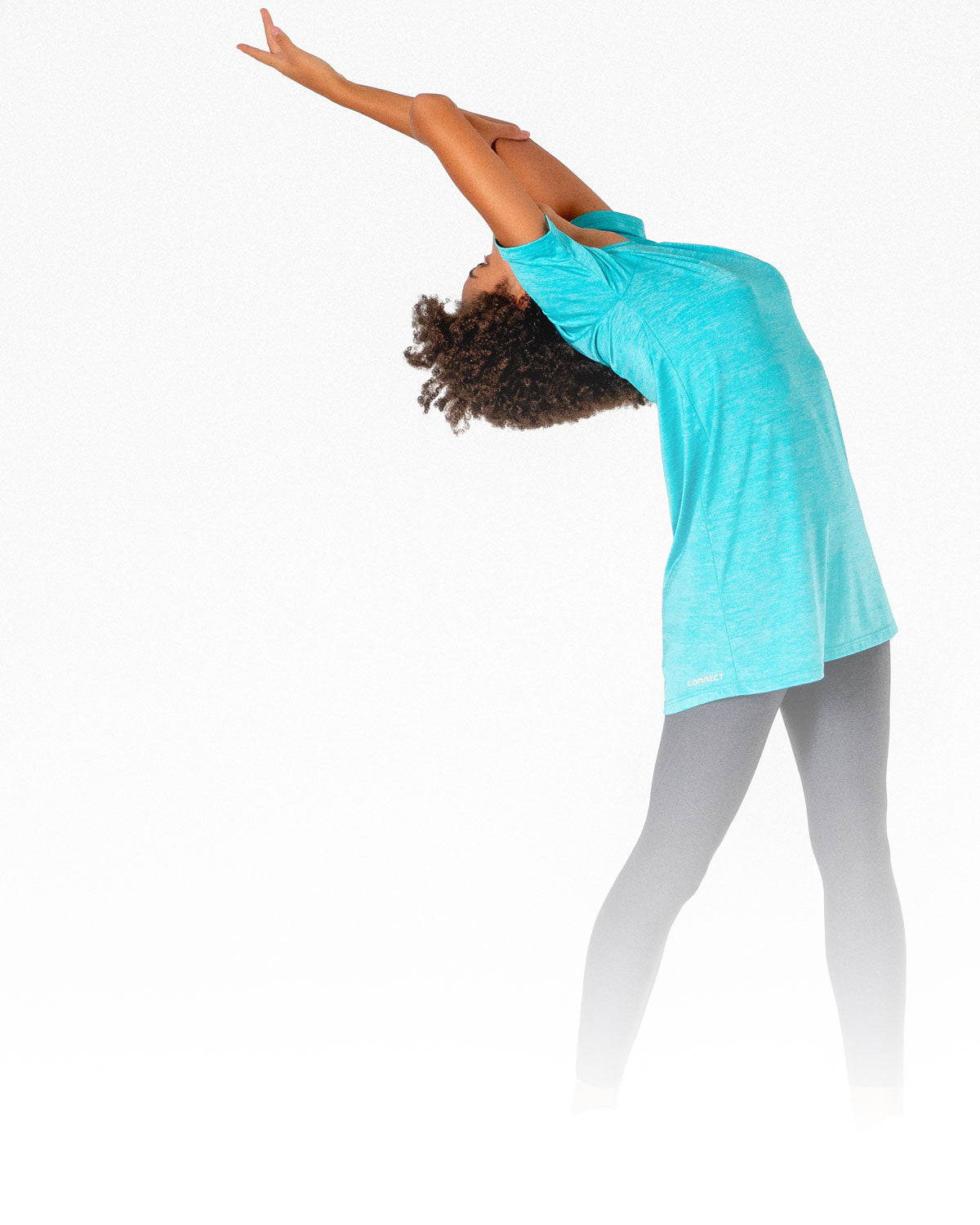Female doing yoga in her Connect T-Shirt Dress, a modest activewear t-shirt from Veil Garments.