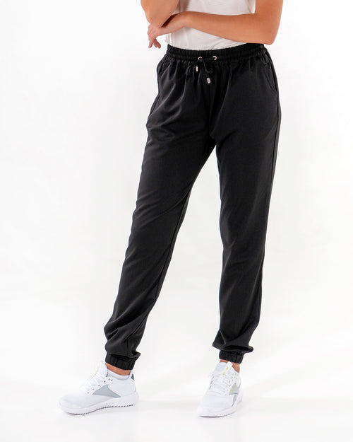 Glider Drawstring Jogger in black, front view of the loose leg and drawstring waist, worn with a white tee.

#color_black