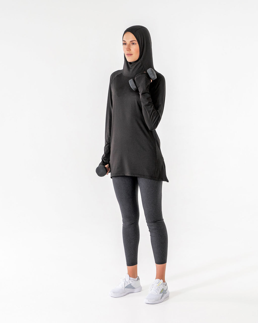 Full-length black Halo Running Hoodie, hood up, curling a dumbbell with one arm.

#color_black