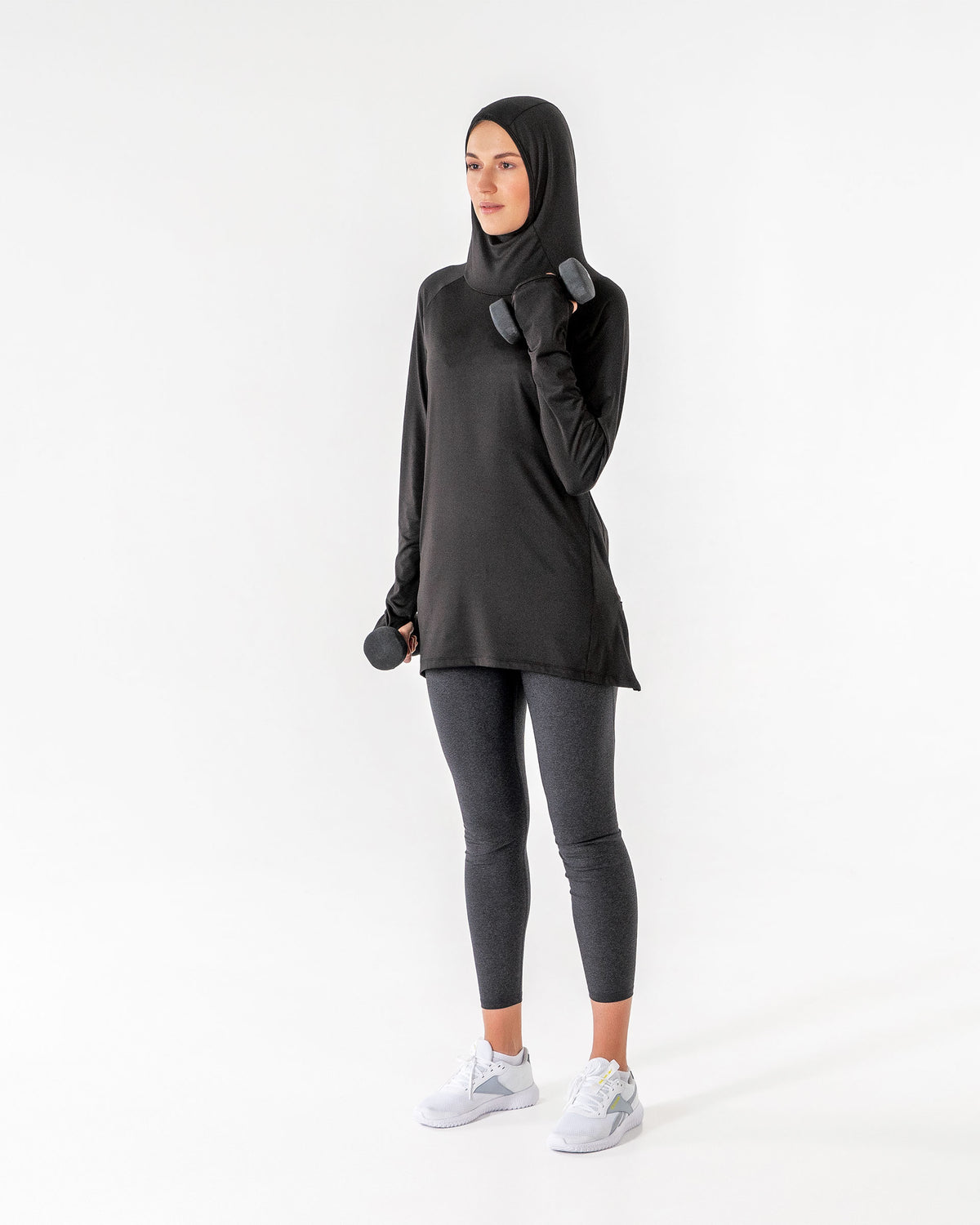 Full-length black Halo Running Hoodie, hood up, curling a dumbbell with one arm.

#color_black