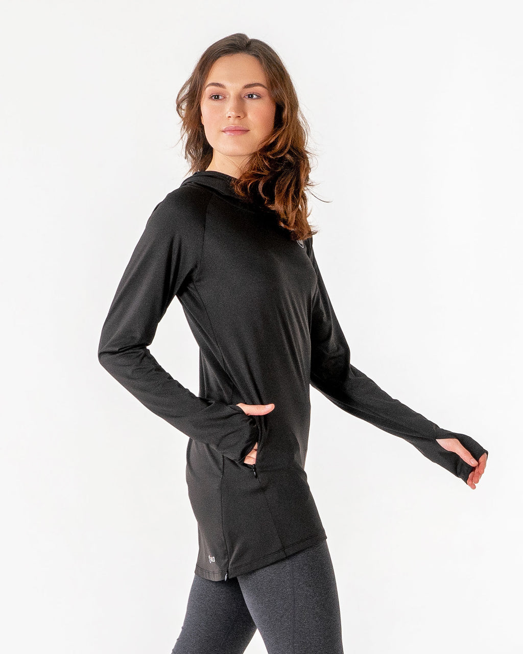 Black Halo Running Hoodie from the side with a hand in the hidden front pocket.

#color_black