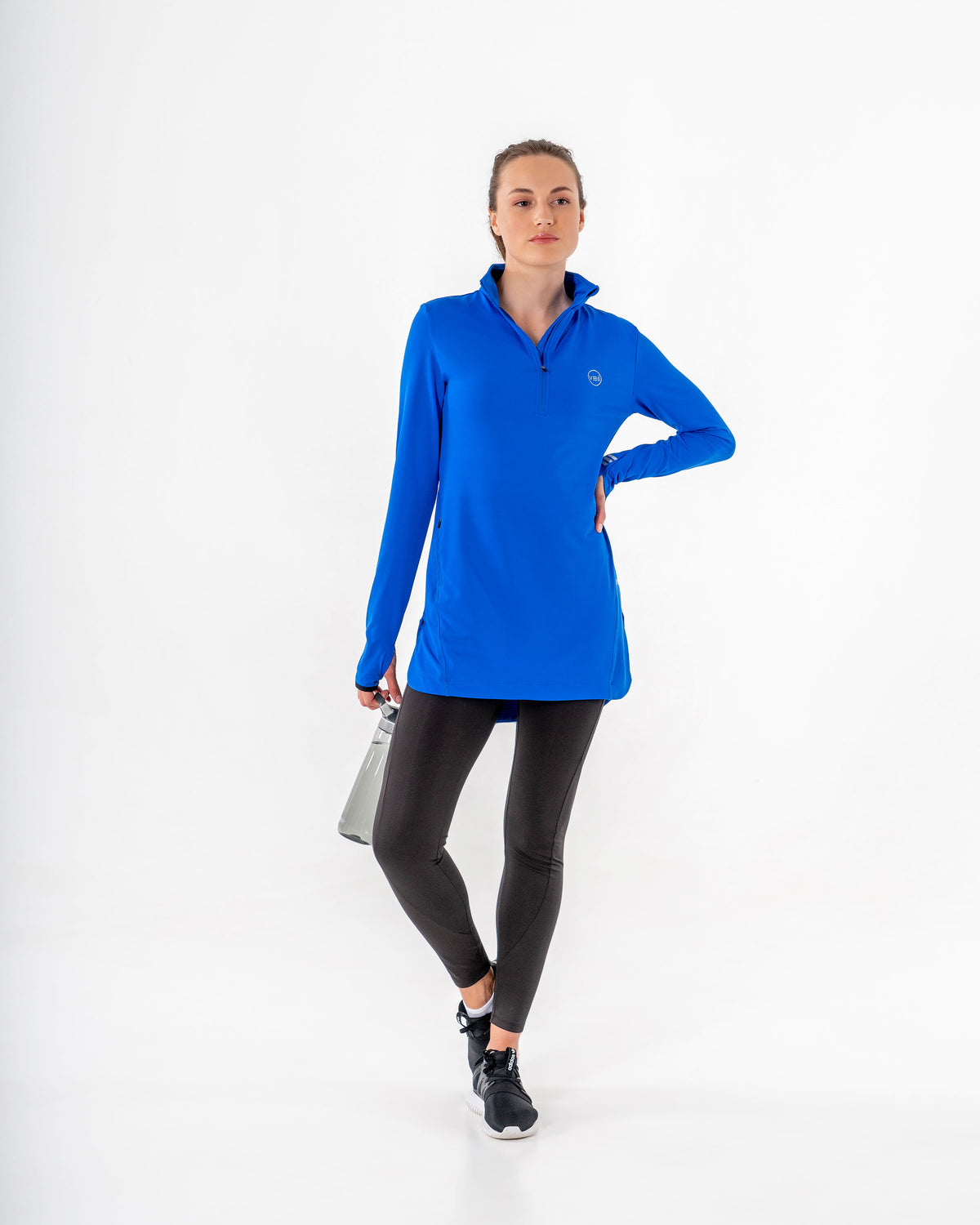 Spark Half-Zip in royal blue with black leggings, full length front view, bottle in one hand.

#color_royal-blue