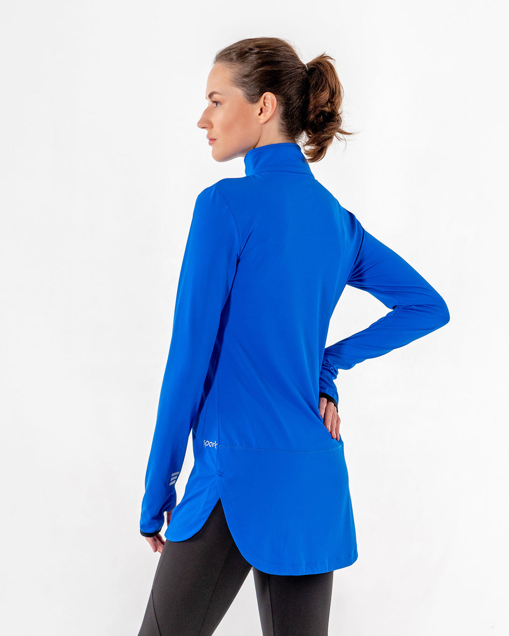 Spark Half-Zip in royal blue from the back at an angle, showing the dropped curved hem.

#color_royal-blue