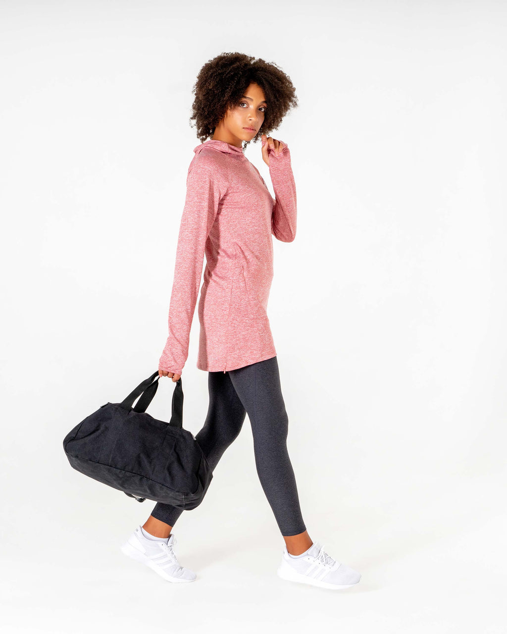 Heathered red Halo Running Hoodie head to toe with grey leggings, carrying a gym bag.

#color_heathered-red