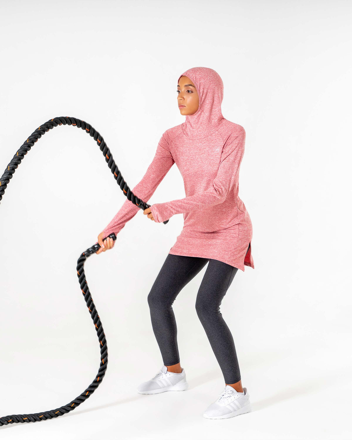 Heathered red Halo Running Hoodie mid-movement on the ropes, hood up and the side slit opening.

#color_heathered-red