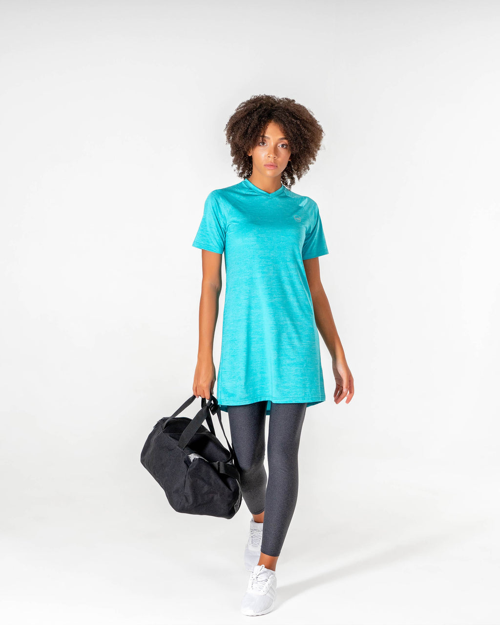 Full-length view of the Connect T-Shirt Dress in Turquoise/Metallic Silver, worn with leggings and a gym bag.

#color_turquoise-metallic-silver